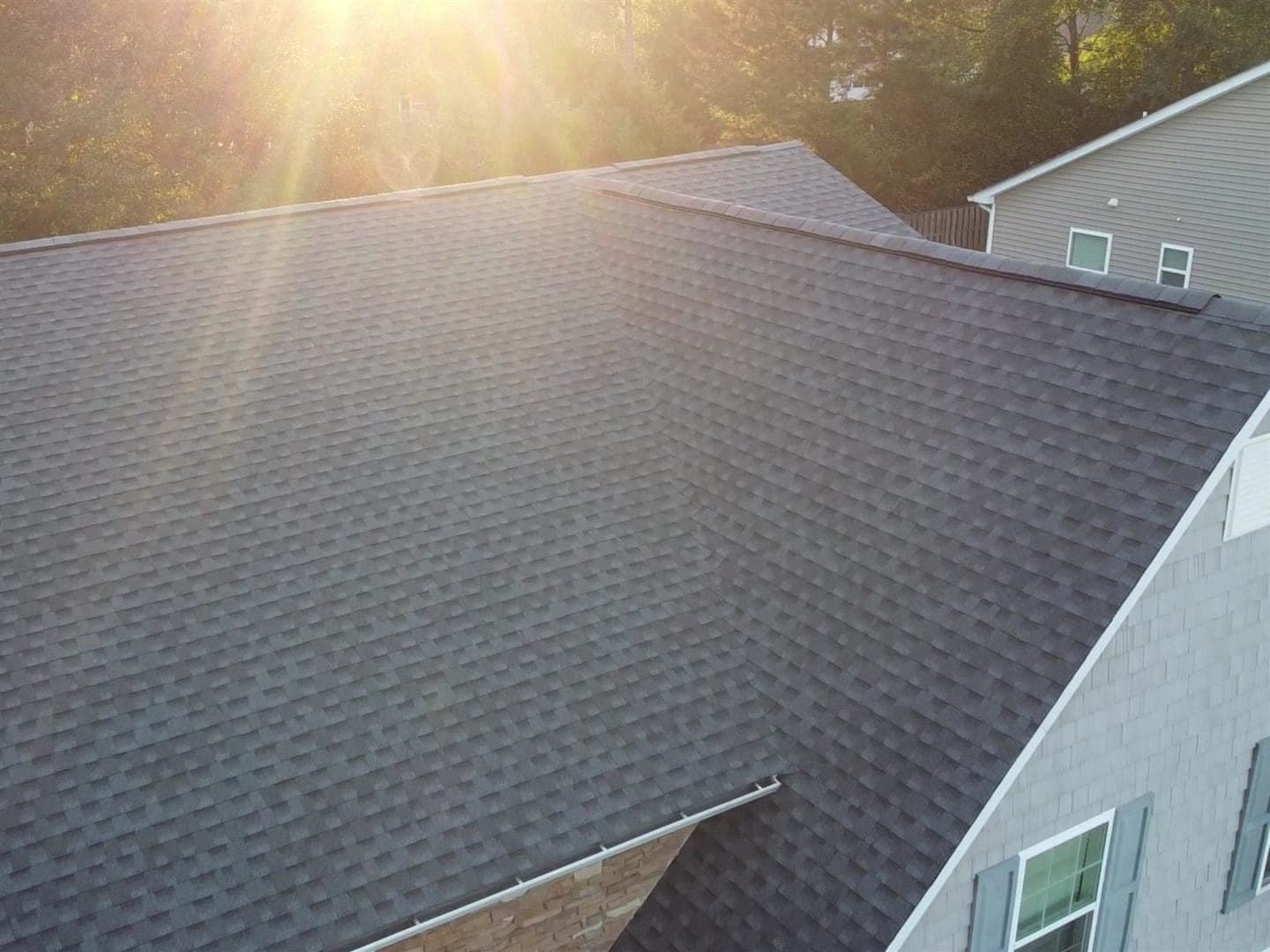 Completed architectural shingle roof replacement, drone view