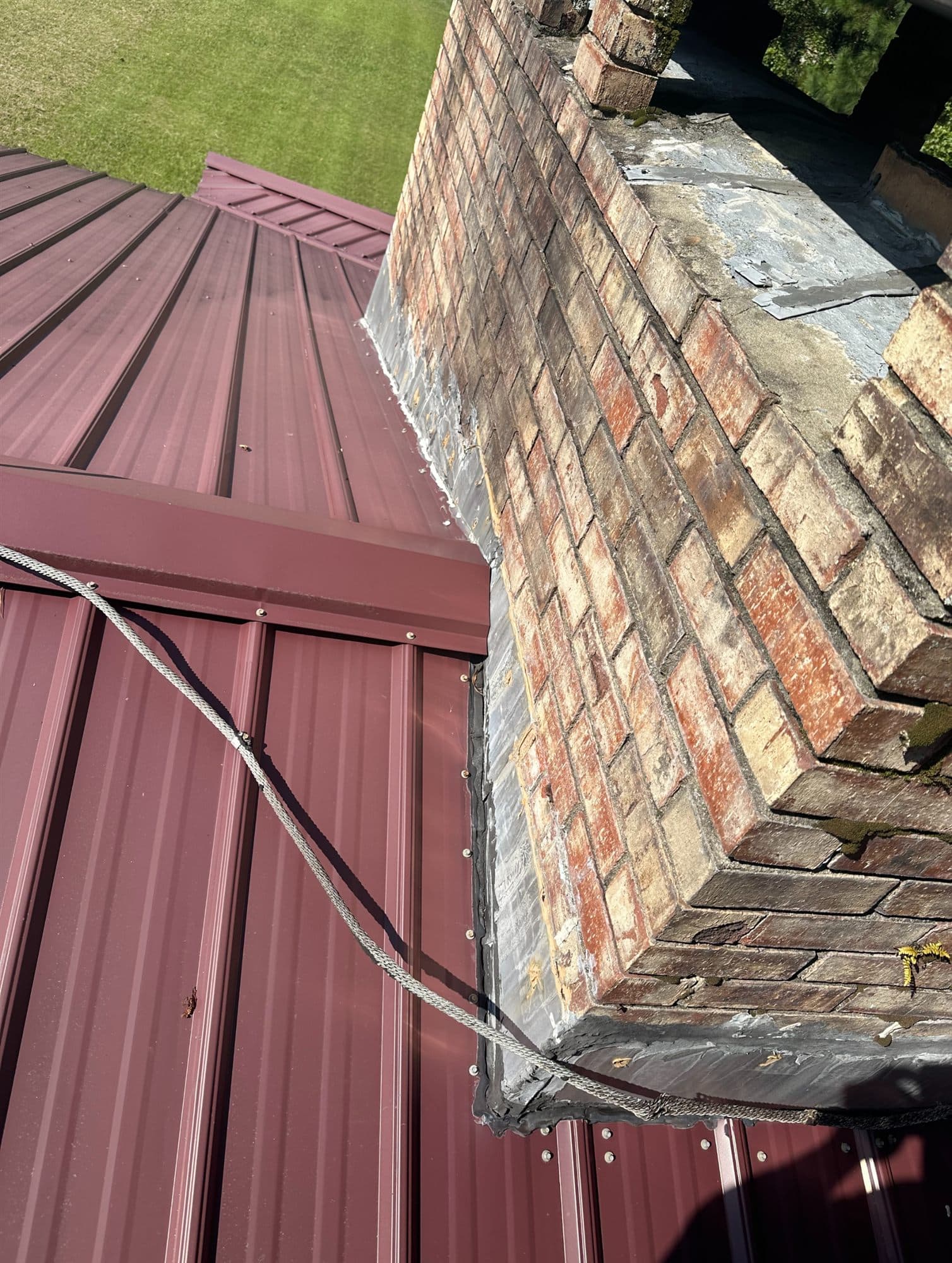 Standing seam metal roof and rebuilt chimney flashing detail